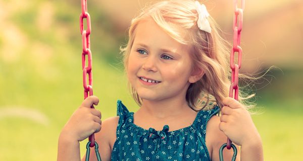 little-girl-is-riding-on-a-swing-PR9S7YH.jpg